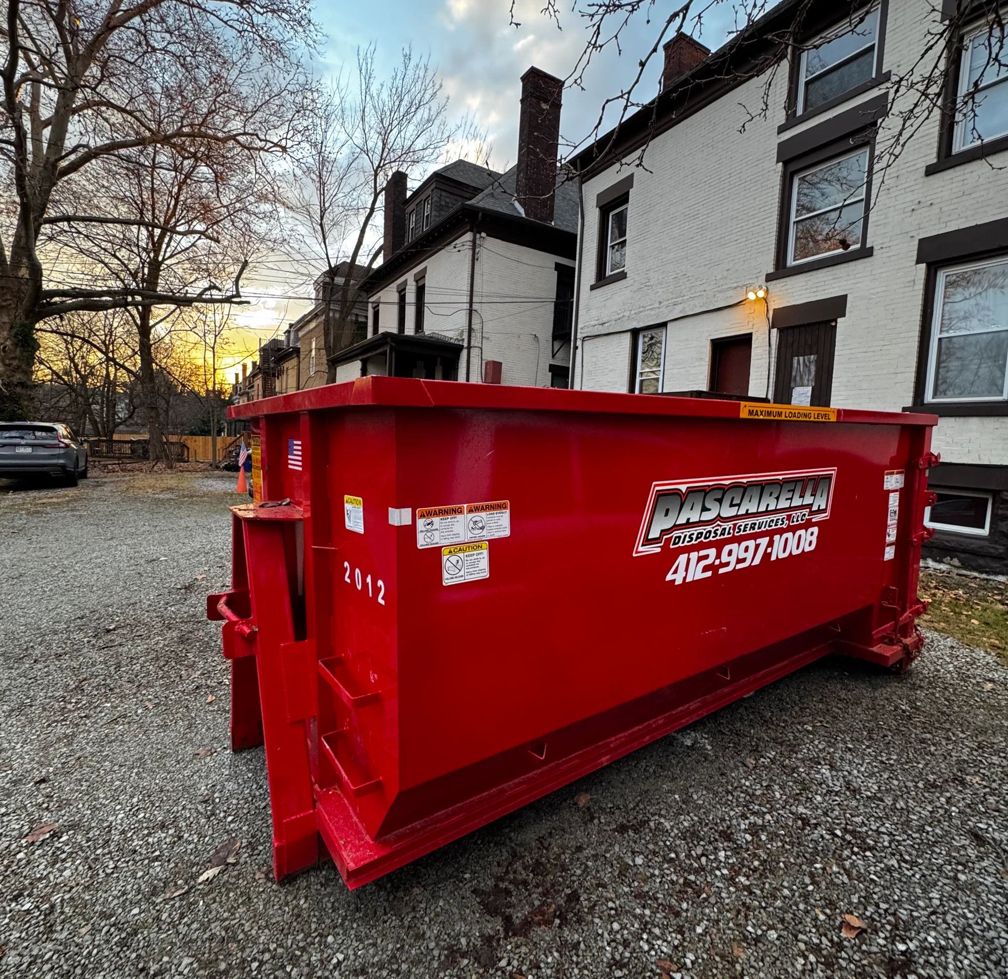 Pascarella dumpster at sunset on a Pittsburgh property