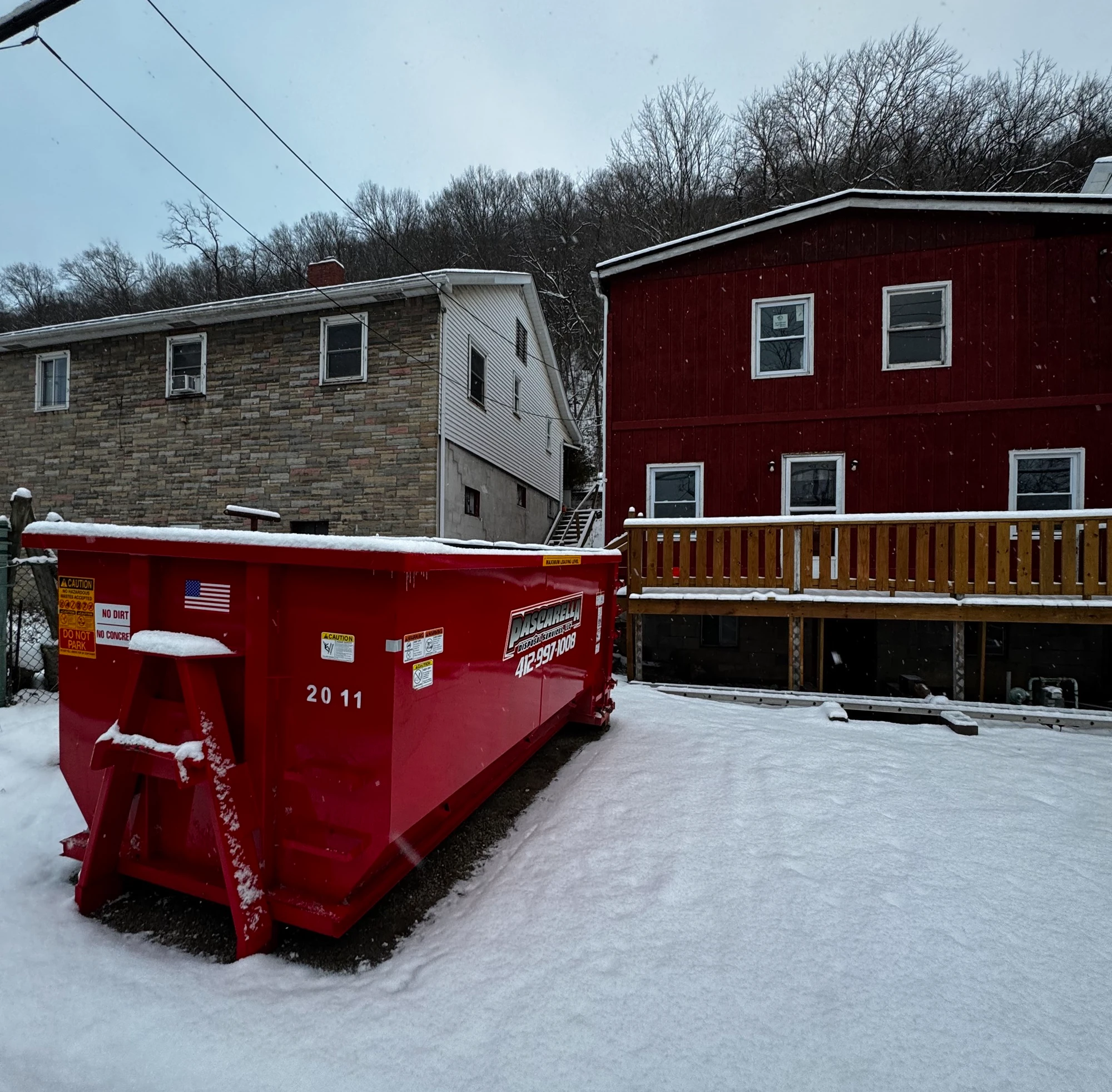 Pascarella dumpster in a snowy Mon Valley backyard